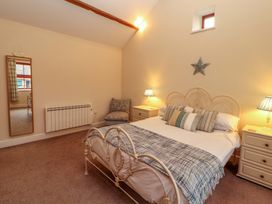 A bedroom with a bed and nightstands at The Old Bothy Bolton Low Houses near Wigton