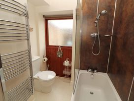 A bathroom with a shower and bathtub at The Old Bothy in Bolton Low Houses near Wigton