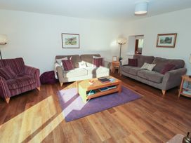 A living room with a sofa and armchairs at The Old Grainstore Bolton Low Houses near Wigton