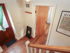 An entrance hall with a front door and staircase at The Old Grainstore Bolton Low Houses near Wigton