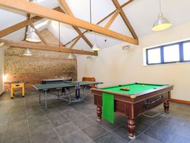 A game room with a pool table ping pong table and foosball table at The Old Stables in Winterborne Stickland