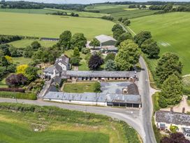 An outdoor area with buildings and fields at The Old Stables Winterborne Stickland