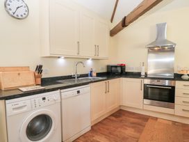 A kitchen with various appliances and cabinets at Corner Barn Winterborne Stickland