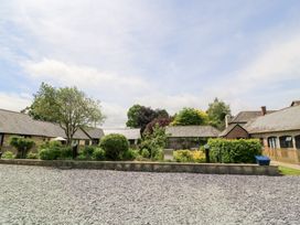 An outdoor area with buildings and greenery at Corner Barn Winterborne Stickland