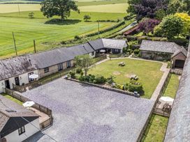 An outdoor area with buildings and garden at Corner Barn Winterborne Stickland