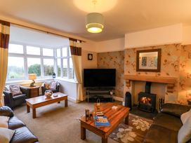 A living room with a fireplace and sofa at Dilston House in Goathland