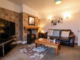 A living room with a sofa and television at Dilston House in Goathland