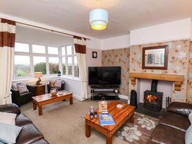 A living room with a sofa, coffee table, and television at Dilston House in Goathland