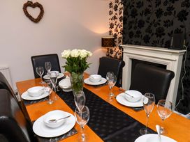 A dining room with a table set for a meal at Dilston House in Goathland