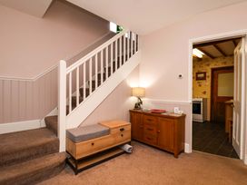 A hallway with a staircase and console table at Dilston House Goathland