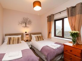 A bedroom with two beds and a chest of drawers at Dilston House in Goathland