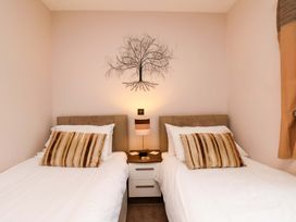 A bedroom with two single beds and a tree decoration at Dilston House Goathland