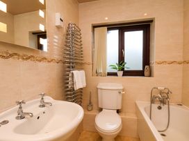 A bathroom with a sink, toilet, and bathtub at Dilston House in Goathland