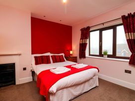 A bedroom with a double bed and bedside table at Dilston House in Goathland