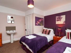 A bedroom with two beds and a washbasin at Dilston House in Goathland