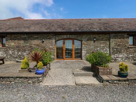 An entrance with double doors and potted plants at The Dairy in Penuel near Llanmorlais