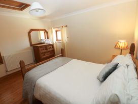 A bedroom with a bed and a chest of drawers at The Dairy in Penuel near Llanmorlais