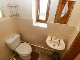 A bathroom with a toilet and sink at The Dairy in Penuel near Llanmorlais