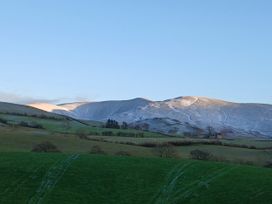 A view of hills and mountains under a clear sky at Riddings Barn Howgill near Sedbergh