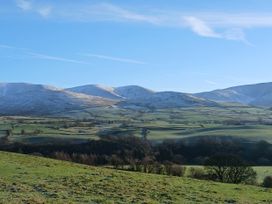 A landscape with mountains and fields at Riddings Barn Howgill near Sedbergh