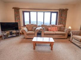 A living room with sofas and a television at Ghyll Bank House Staveley near Windermere