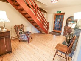 A hallway with a staircase and furniture at Ghyll Bank House Staveley near Windermere