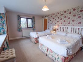 A bedroom with two beds and a window at Ghyll Bank House Staveley near Windermere