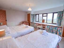 A bedroom with two beds and a dressing table at Ghyll Bank House Staveley near Windermere