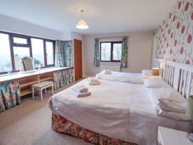 A bedroom with two beds and a dressing table at Ghyll Bank House Staveley near Windermere
