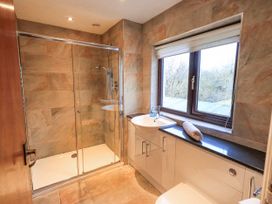 A bathroom with a shower, sink and toilet at Ghyll Bank House Staveley near Windermere