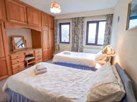 A bedroom with two beds and a desk at Ghyll Bank House Staveley near Windermere