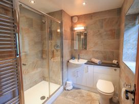 A bathroom with a shower, toilet, and sink at Ghyll Bank House Staveley near Windermere