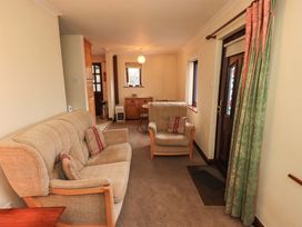 A living room with sofa and armchairs at Ghyll Bank Bungalow Staveley near Windermere