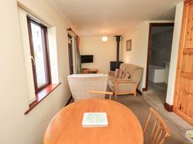A living room with a sofa and table at Ghyll Bank Bungalow Staveley near Windermere