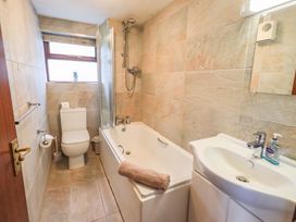 A bathroom with a bathtub, toilet, and sink at Ghyll Bank Bungalow Staveley near Windermere