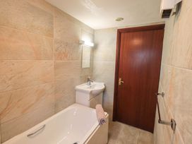 A bathroom with a bathtub and sink at Ghyll Bank Bungalow Staveley near Windermere