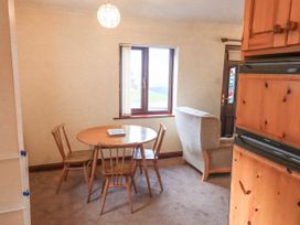 A dining room with a table and chairs at Ghyll Bank Bungalow Staveley near Windermere