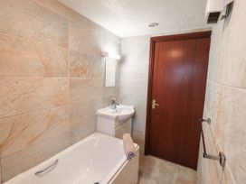 A bathroom with a bathtub and sink at Ghyll Bank Bungalow Staveley near Windermere