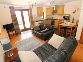 A living room with a sofa and TV at The Stall in Penuel near Llanmorlais