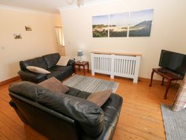 A living room with sofas and a television at The Stall in Penuel near Llanmorlais