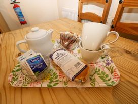 A dining room table with tea set and cake at The Stall in Penuel near Llanmorlais