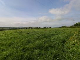 A field with grass and clouds at The Stall in Penuel near Llanmorlais
