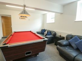 A game room with a pool table and sofas at Minerva Trearddur Bay