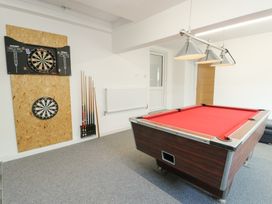A game room with a pool table and darts boards at Minerva in Trearddur Bay