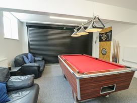 A game room with a pool table and dartboard at Minerva in Trearddur Bay