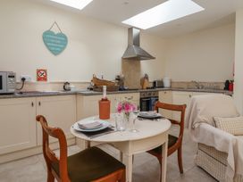A kitchen with a round table and chairs at Stable Cottage in Cawton near Hovingham