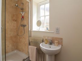 A bathroom with a shower and sink at Stable Cottage Cawton near Hovingham