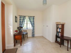 A hallway with a chair and table at Stable Cottage in Cawton near Hovingham
