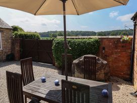 An outdoor dining area with table and chairs at Stable Cottage Cawton near Hovingham