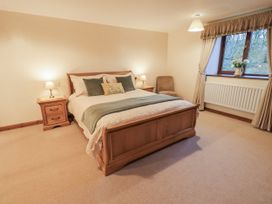 A bedroom with a bed and bedside tables at Christine's Stable Shap near Maulds Meaburn